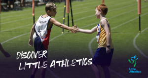 Two boys shaking hands at the end of a running race.